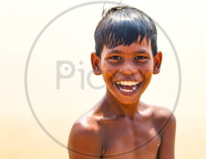 Indian Boy smiling when he drenched in Water