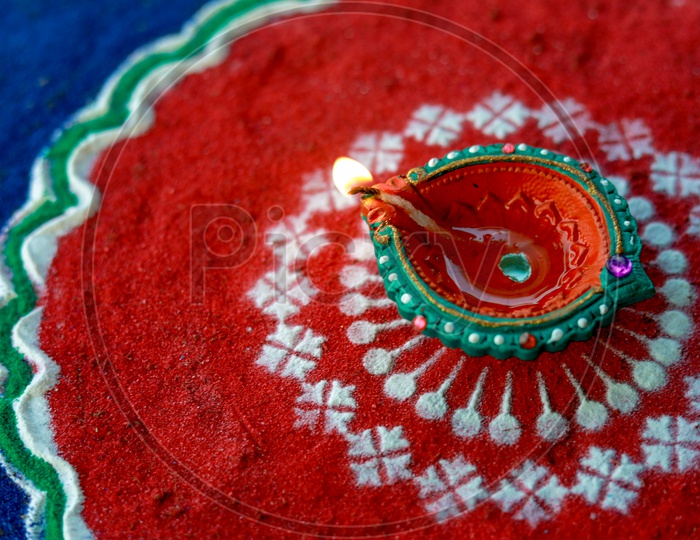 Indian Festival Diwali, Diwali Lamp, Deepavali Diyas  between Rangoli