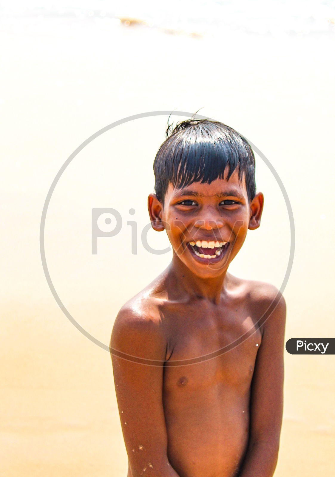 Indian Boy smiling when he drenched in Water