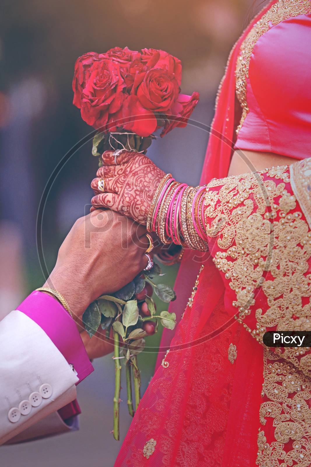 Groom Giving Bride a  Red Roses Bouquet  with Love and in a Romantic Way For Being Together in a Wedding Ceremony