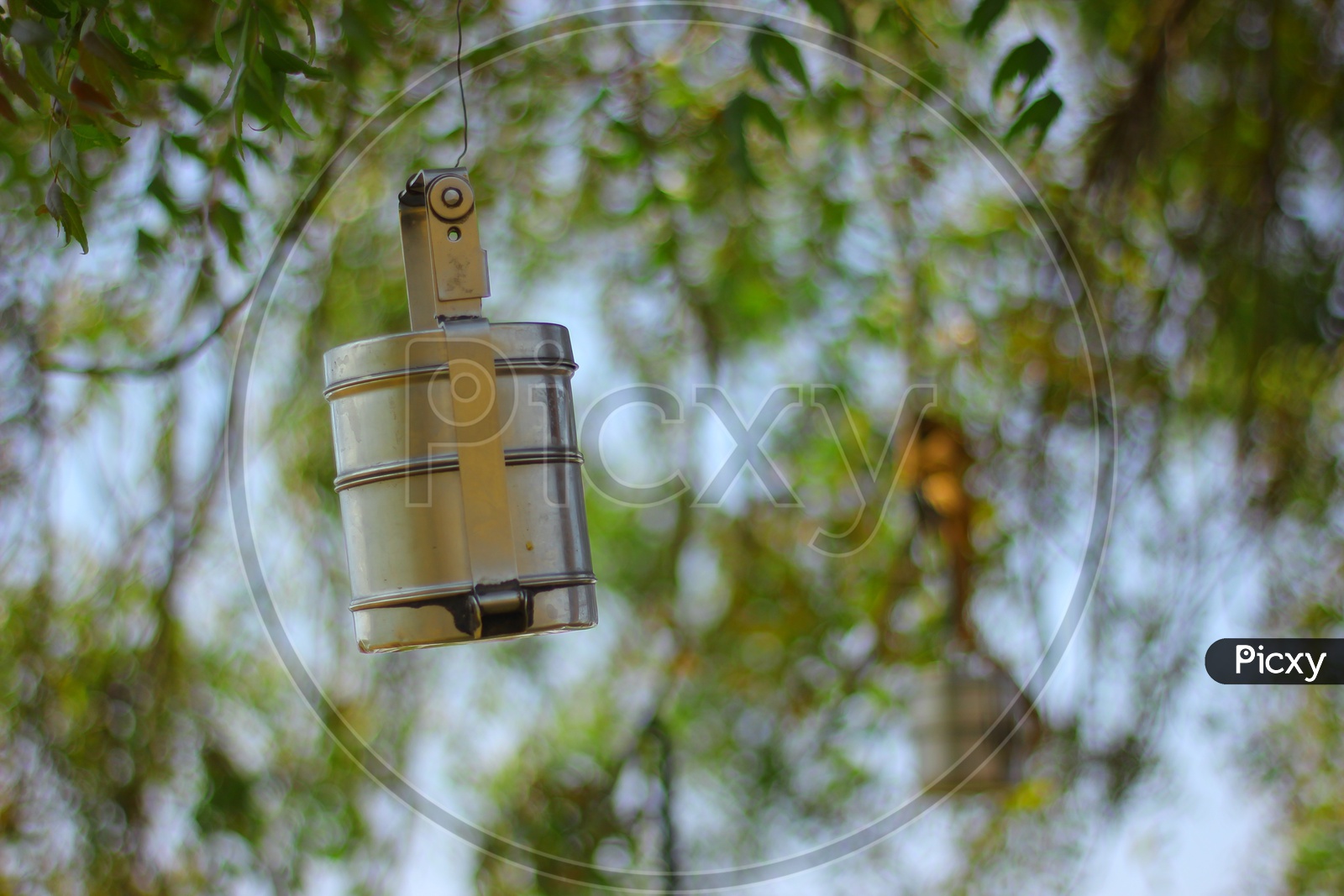 A Lunch Box / Steel Food  Carrier  hanged to tree by a Farmer in his Field