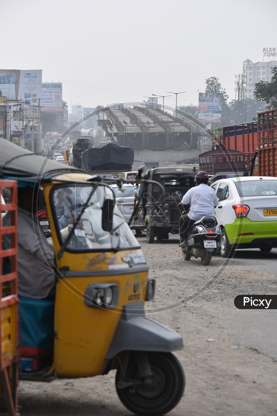 Vehicles moving on a road at underconstruction flyover.