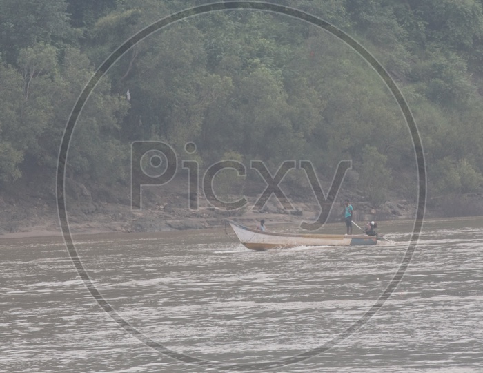 A Man Rowing A boat in River Godavari.
