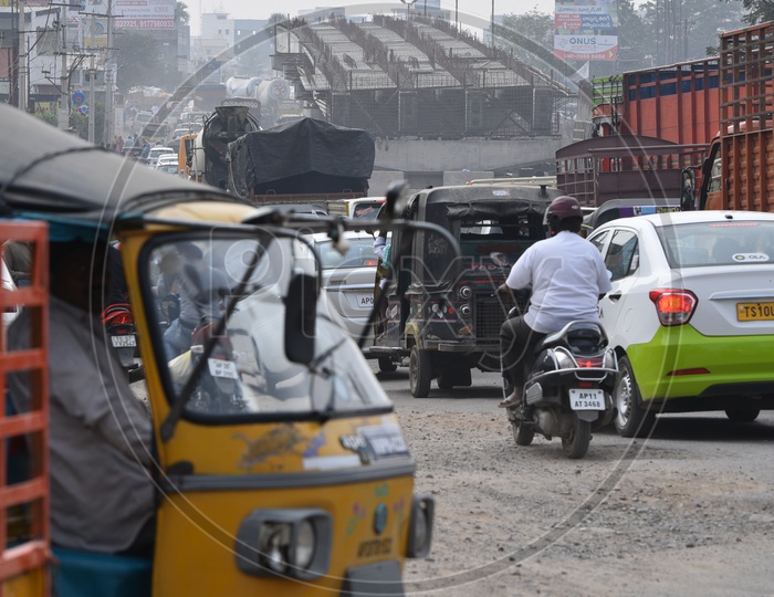 Vehicles moving on a road at underconstruction flyover.
