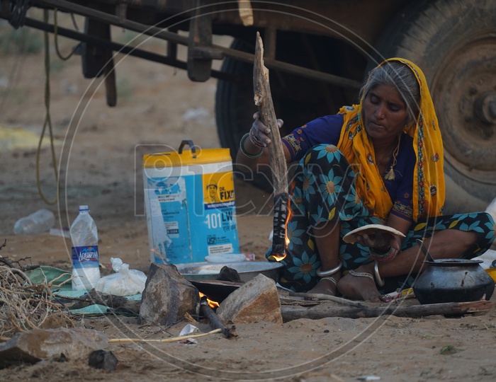 A Woman Cooking In a Traditional Stove in Pushkar fair