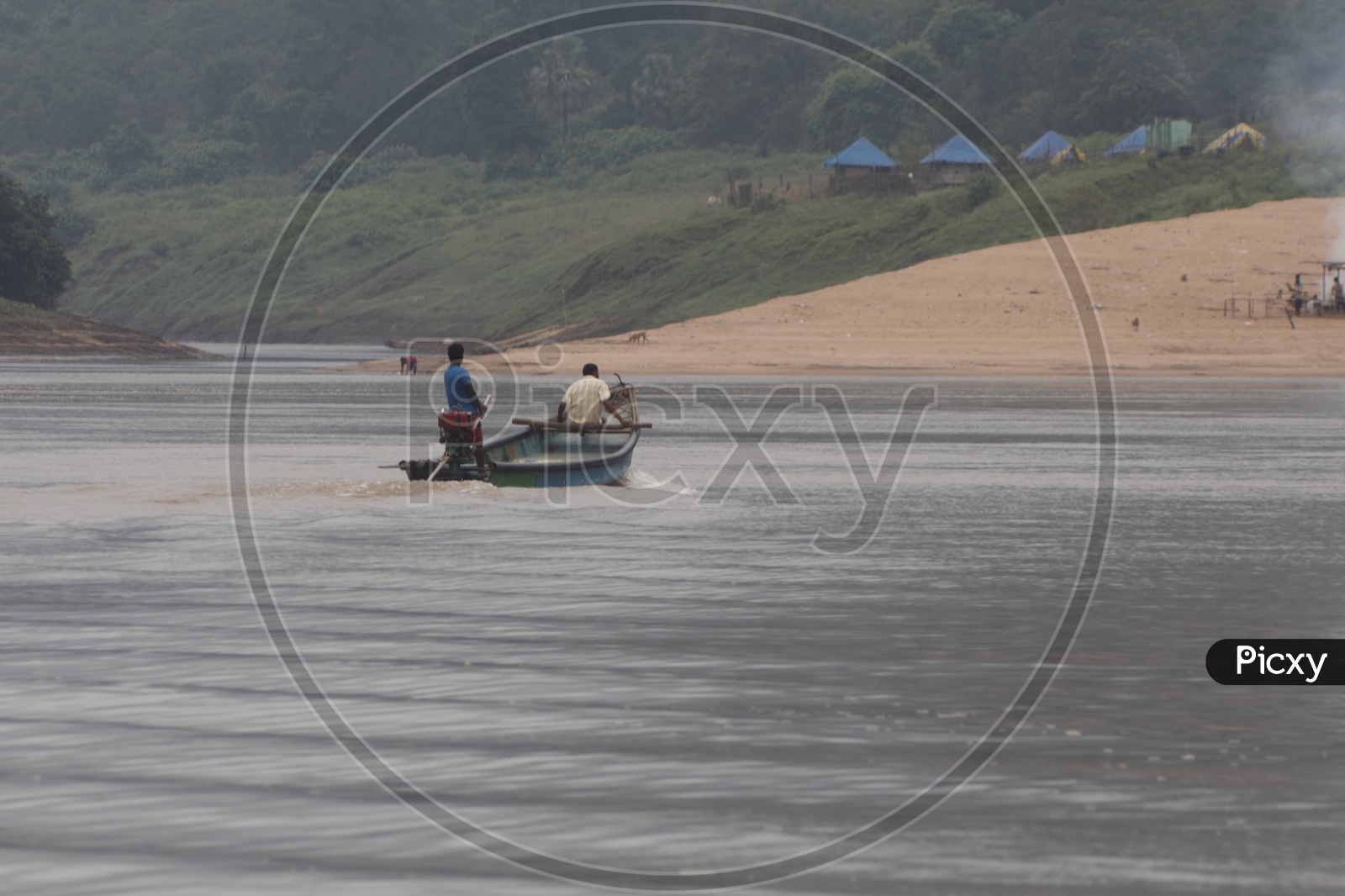 Two men sailing a boat on the river godavari.