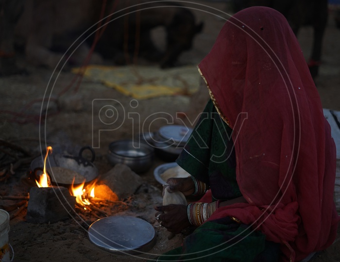 A Woman Making HerDaily Bread in Pushkar in his Traditional Rajasathani Attire