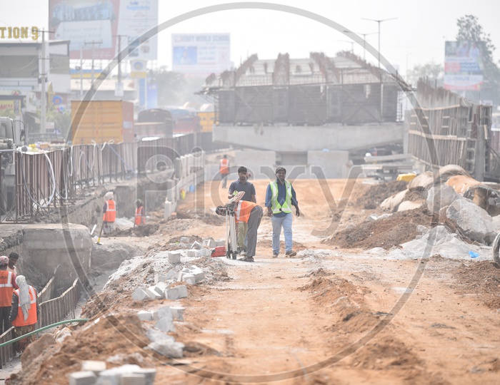 Workers carrying out their works at a underconstruction flyover.