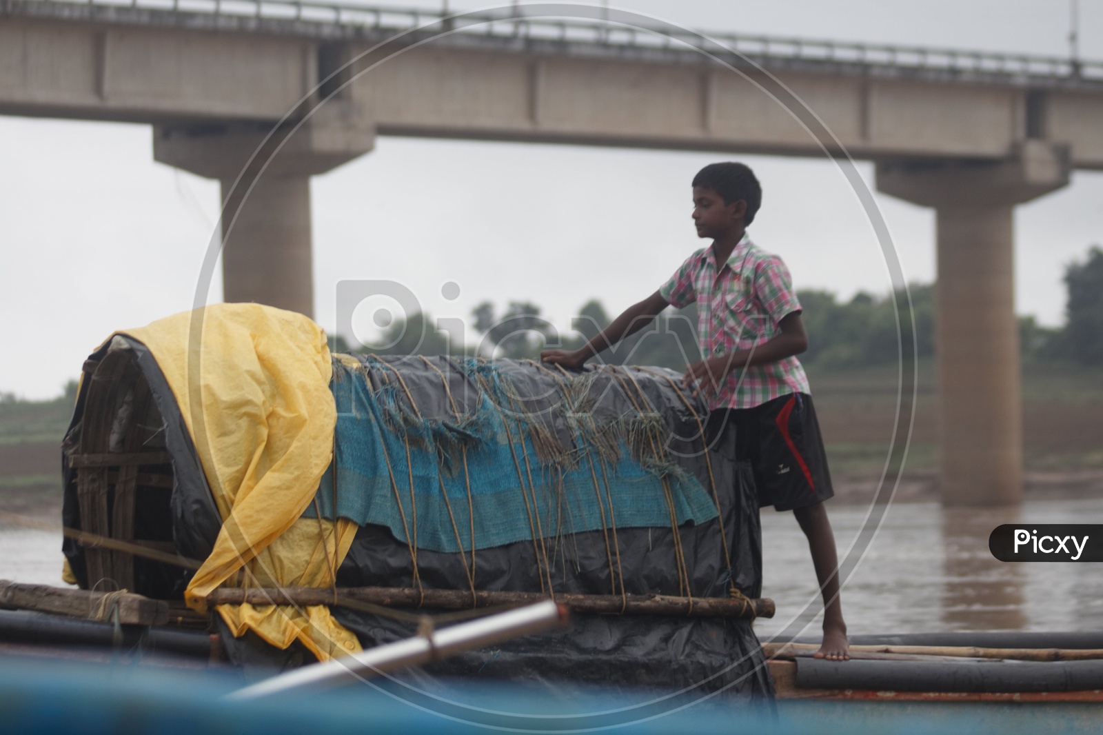 A Boy standing on the boat on river godavari.