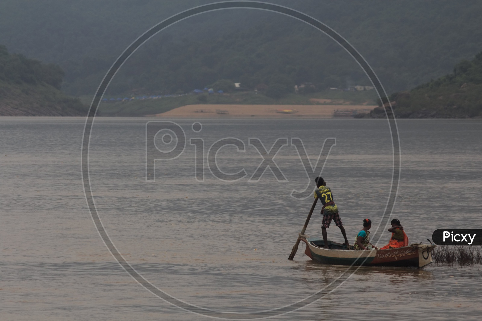 A Man rowing a boat on river godavari.