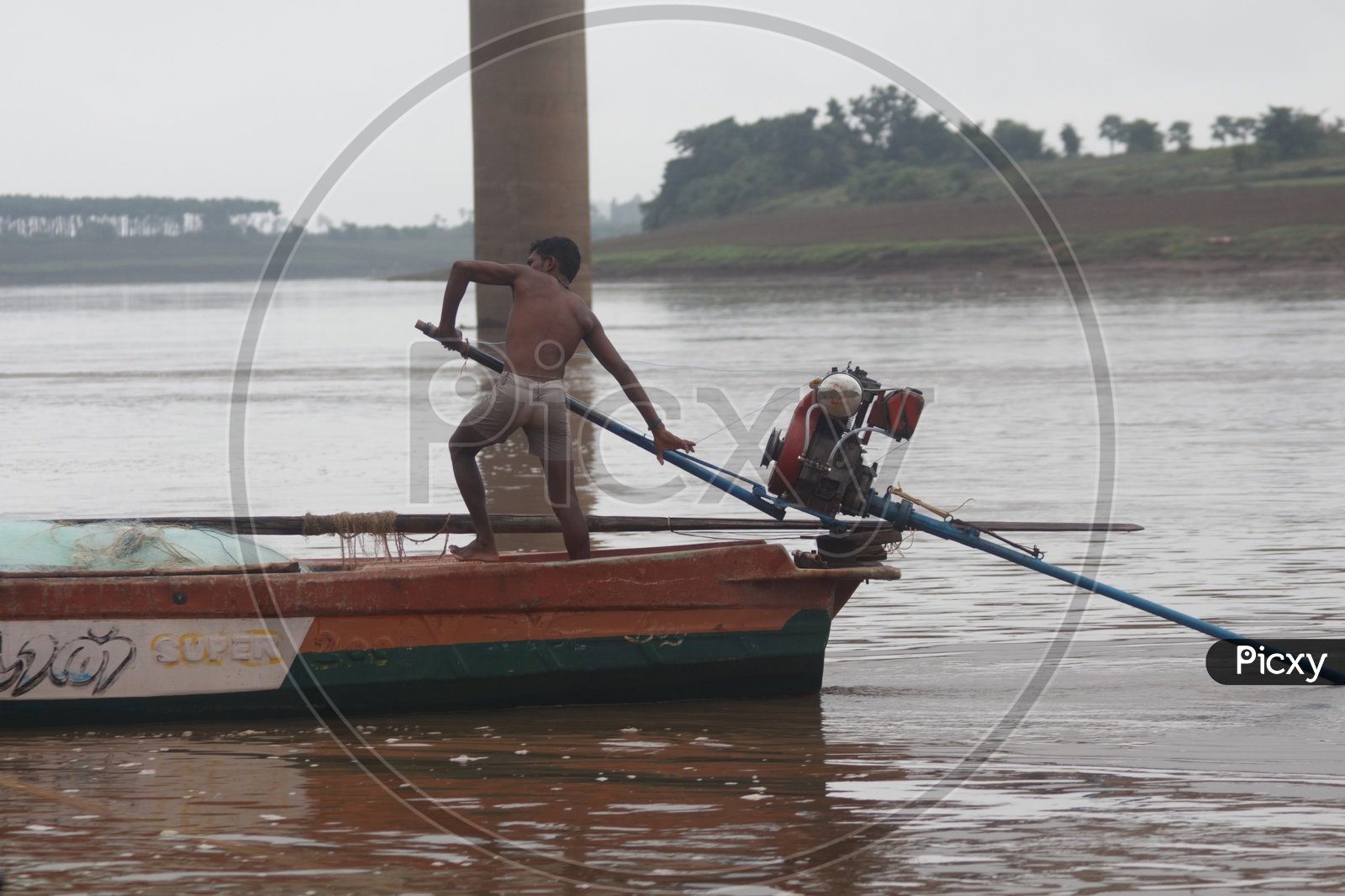 A Man sailing his boat on river godavari.