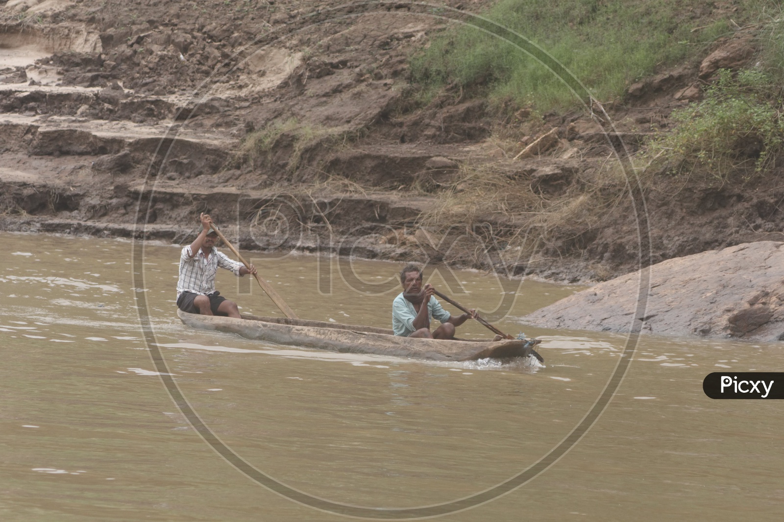 Two men Rowing a boat at river godavari.