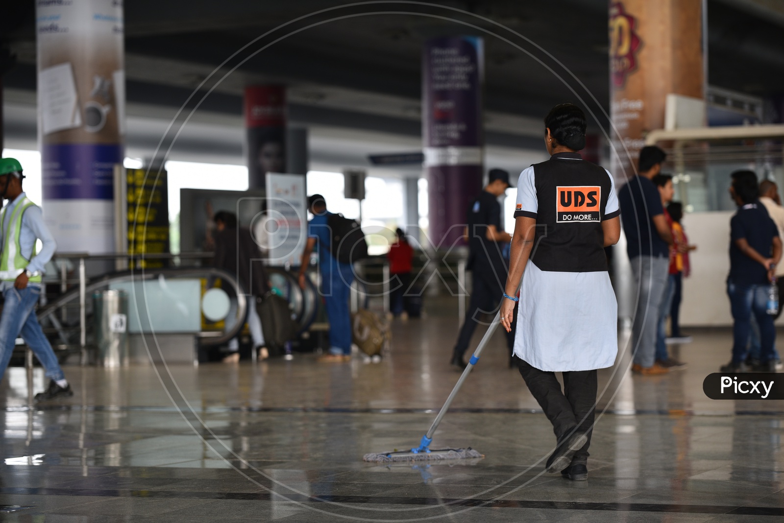 A Staff cleaning the floor in RGI airport.