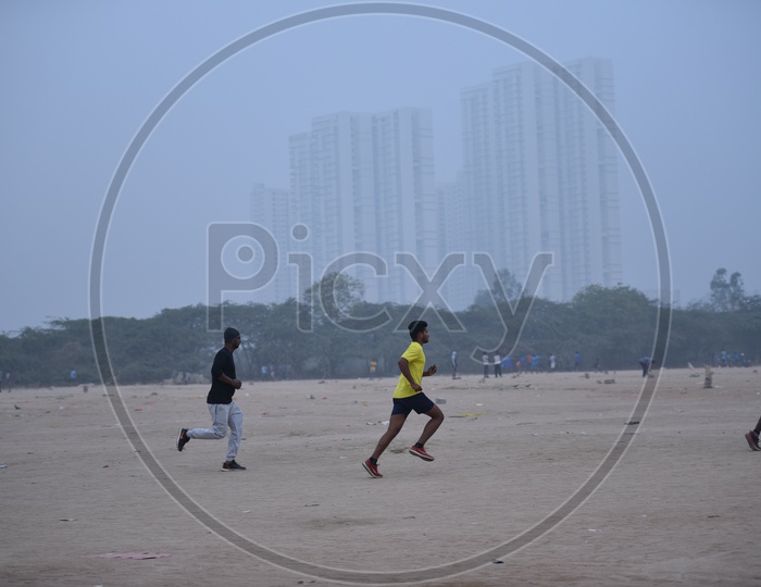 Two men jogging in grounds as a part of morning exercise.