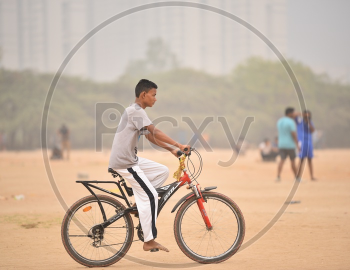 A boy cycling as a part of morning exercise.