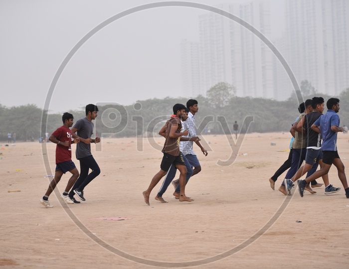 A group of men jogging as a part of morning exercise in the grounds
