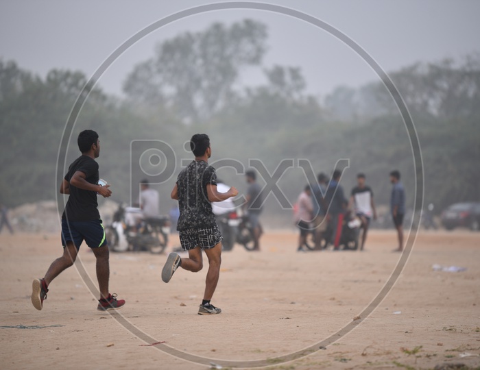 Two men jogging in grounds as a part of morning exercise.