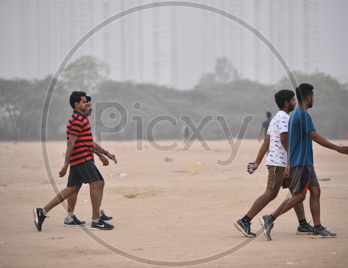 Four men walking in grounds as a part of morning exercise.