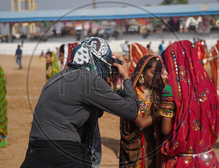 Rajasthani Women Colorfully dressed and Dancing getting Photographed