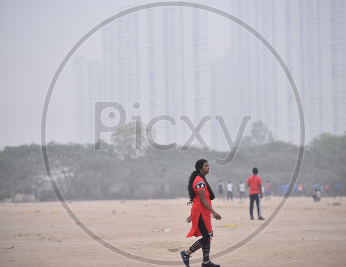 A woman walking in grounds as a part of morning exercise