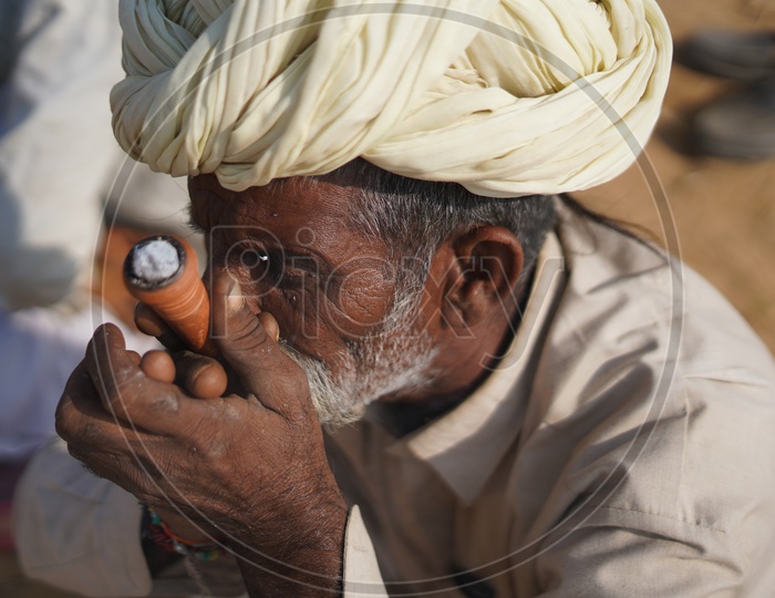 Rajasthani Man smoking at Pushkar Camel Fair, 2018