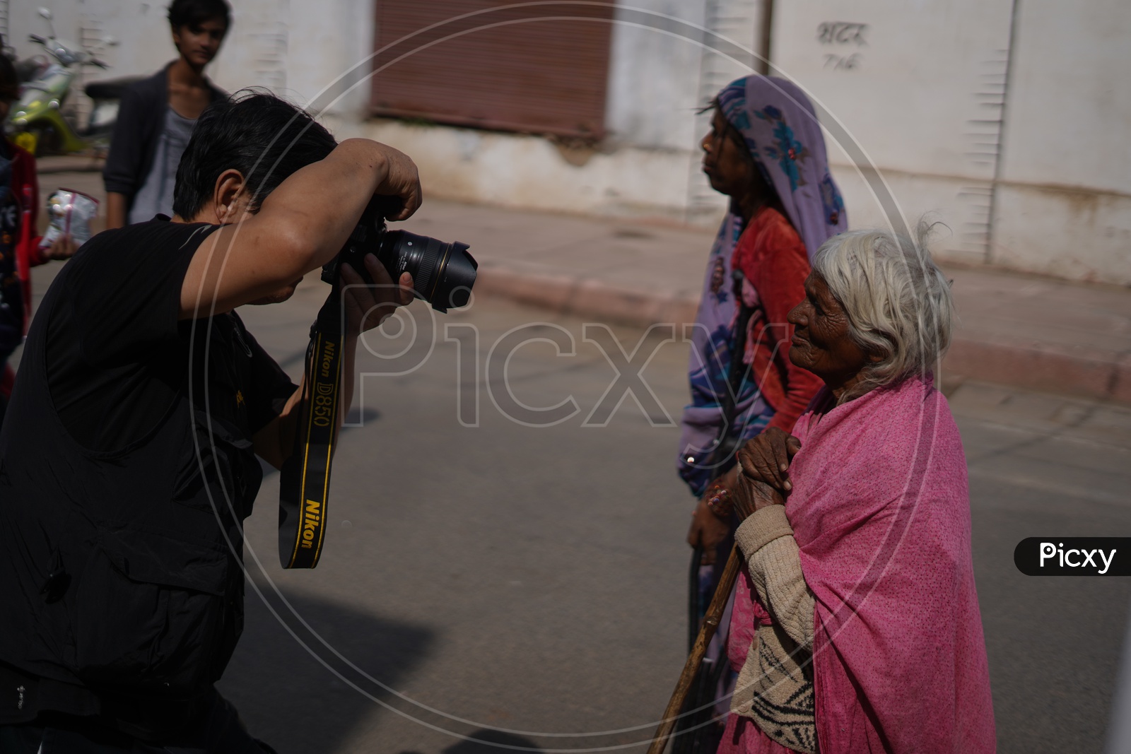 A Photographer Taking  a Picture Of Old lady In Pushkar