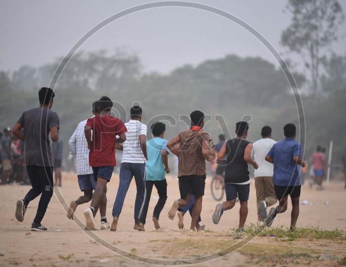 A group of men jogging as a part of morning exercise in the grounds