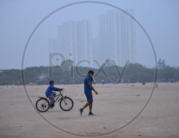A little boy cycling in grounds as a part of morning exercise.