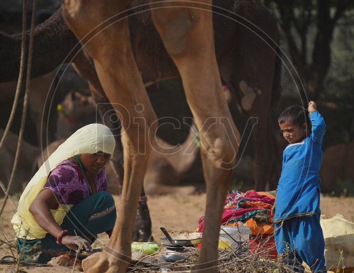 A Woman Preparing Her Daily Bread Spotted Along With her Daughter in Pushkar Camel Fair