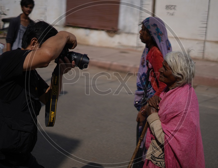 A Photographer Taking  a Picture Of Old lady In Pushkar