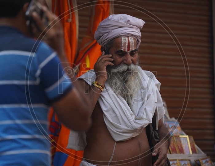 Indian Hindu sadhu / Baba Talking in Phone in Pushkar Camel Fair