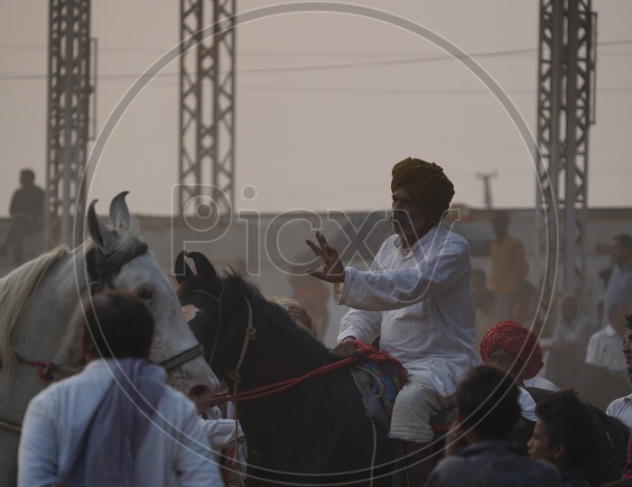 Indian Village Horse Riders in Pushkar Camel Fair Ground, Pushkar, Rajasthan, India