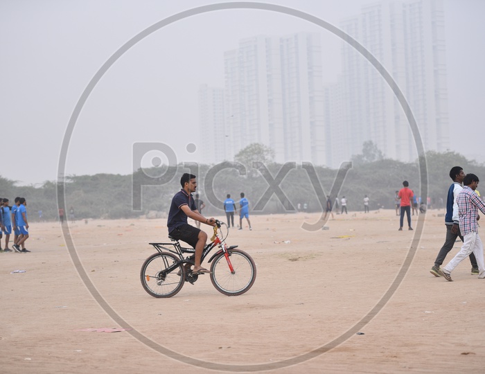 A man cycling in grounds as a part of morning exercise.
