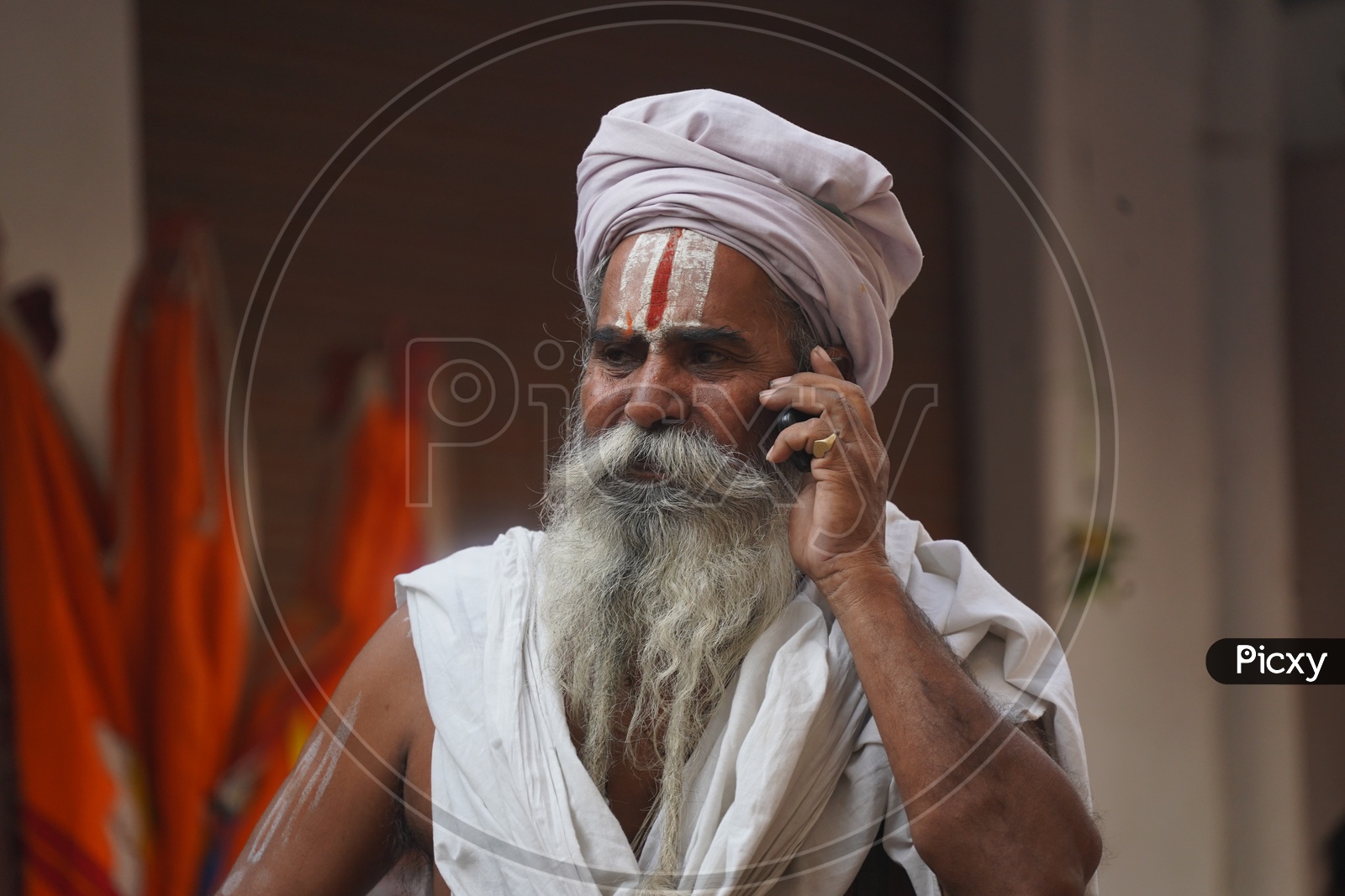 Indian Hindu sadhu / Baba Talking in Phone in Pushkar Camel Fair
