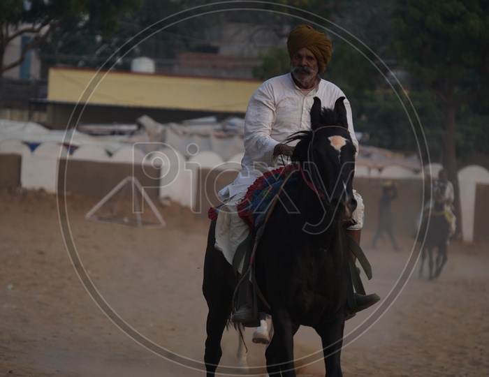 Indian Village Horse Riders at Pushkar Cattle Fair Ground,Pushkar, Rajasthan, India