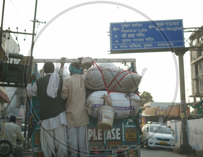 Local People In Pushkar Commuting Dangerously by Hanging on to Backside of Vehicle in Pushkar