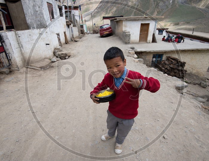 A School boy With His Lunch Plate and Posing For Photo