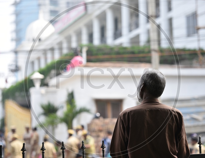 An Old man Looking into TRS Bhavan As The Election Counting Has Going on