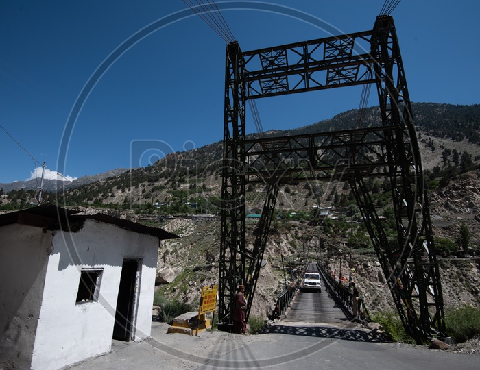 A Car Crossing a Metal  Bridge Constructed Over a Water Canals In Leh / Ladakh