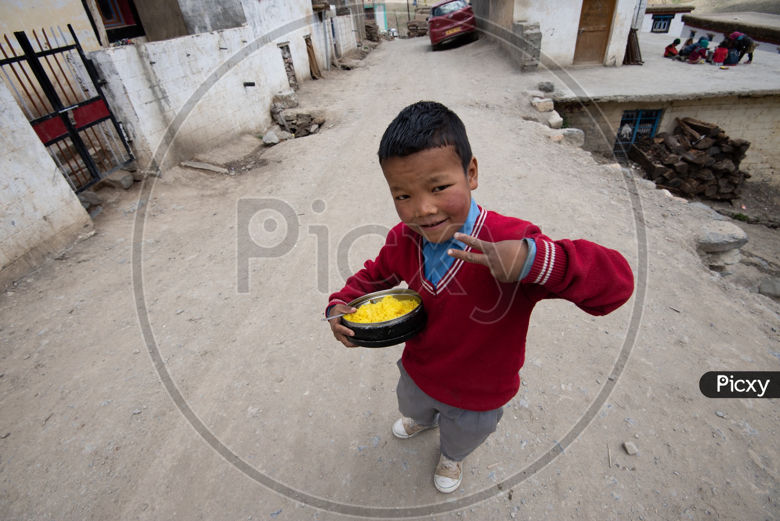 A School Boy with his lunch Box in Hand and Posing to Camera in Ladakh / leh