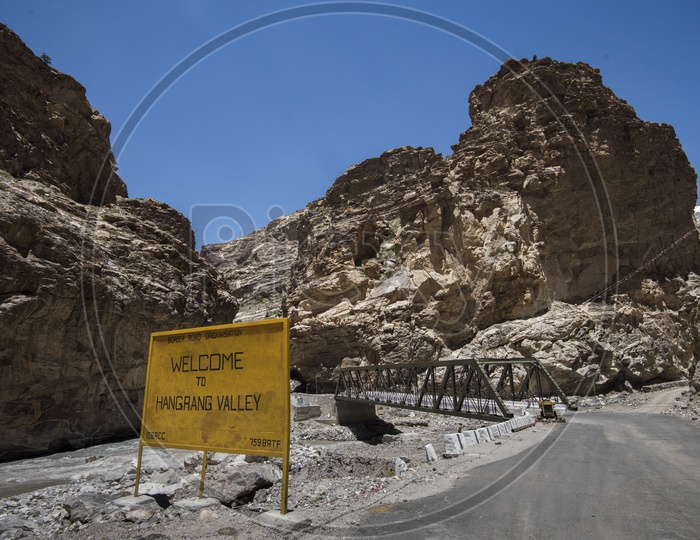 A Bridge Over a Water Canal and a Sign Board Saying Welcome to Hangrang River in Leh / Ladakh