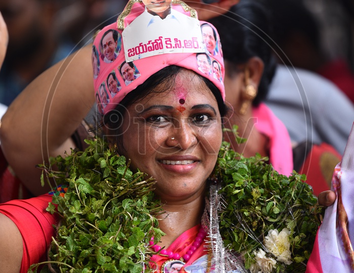 A Lady  Supporter Of TRS Party Wearing TRS Cap with KCR Photo in it In Celebrations of Victory in Telangana Elections 2018