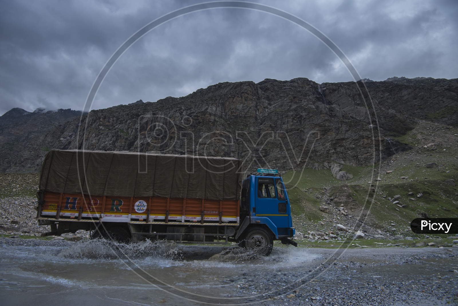 A Vehicle Crossing a Water Pit on road in Leh / Ladakh roads