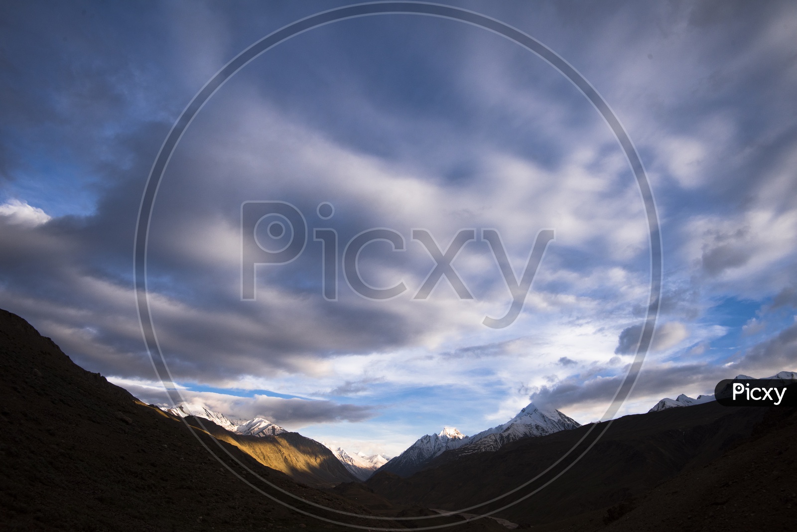 A River Valley Views Of Leh / Ladakh with Clouds and Mountains in Backdrop
