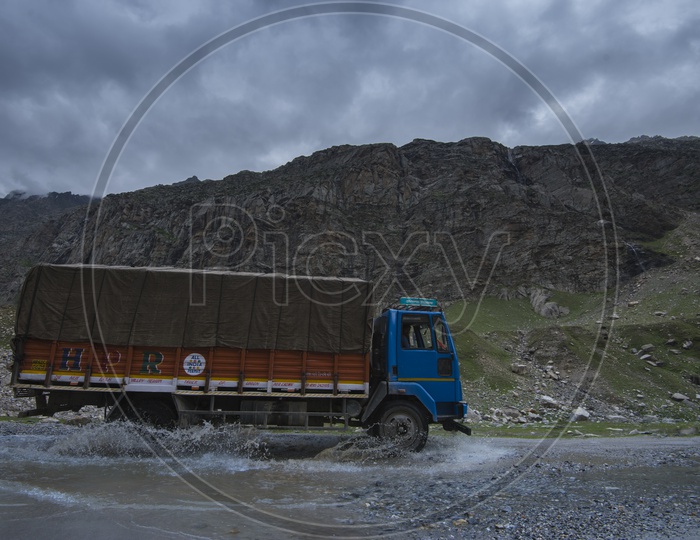 A Vehicle Crossing a Water Pit on road in Leh / Ladakh roads