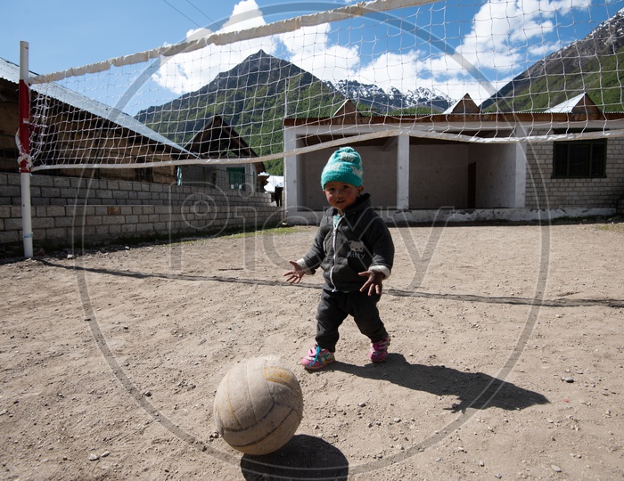 Cute little kid playing with Volley Ball