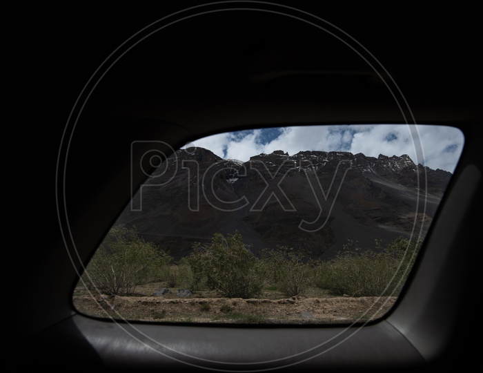 Beautiful Landscape of Snow Capped Mountains from Spiti Valley through a car window