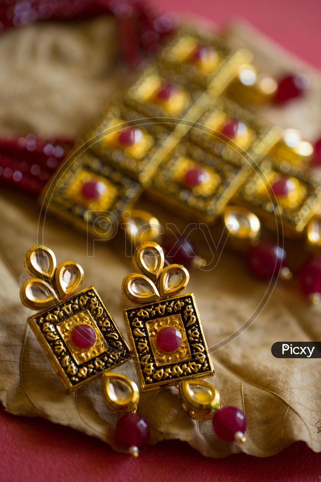 Indian Traditionally Made Designs For Bridal Collection of Gold Jewellery Necklace and Ear Rings Set Closeup Shot