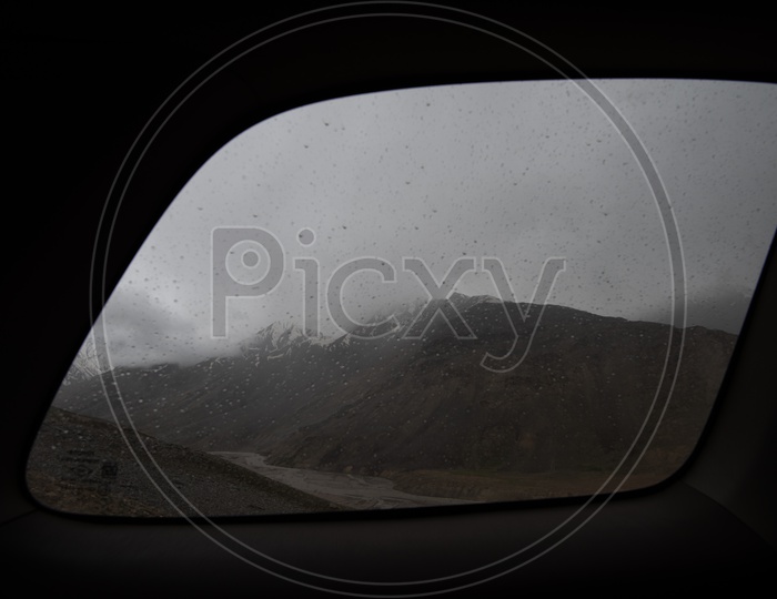 Beautiful Landscape of Snow Capped Mountains from a car window, Spiti Valley