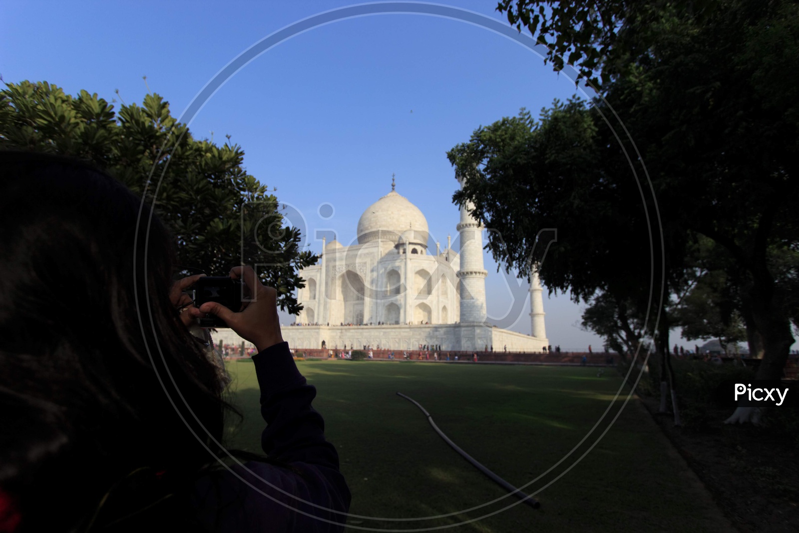 Photographer clicking Taj Mahal